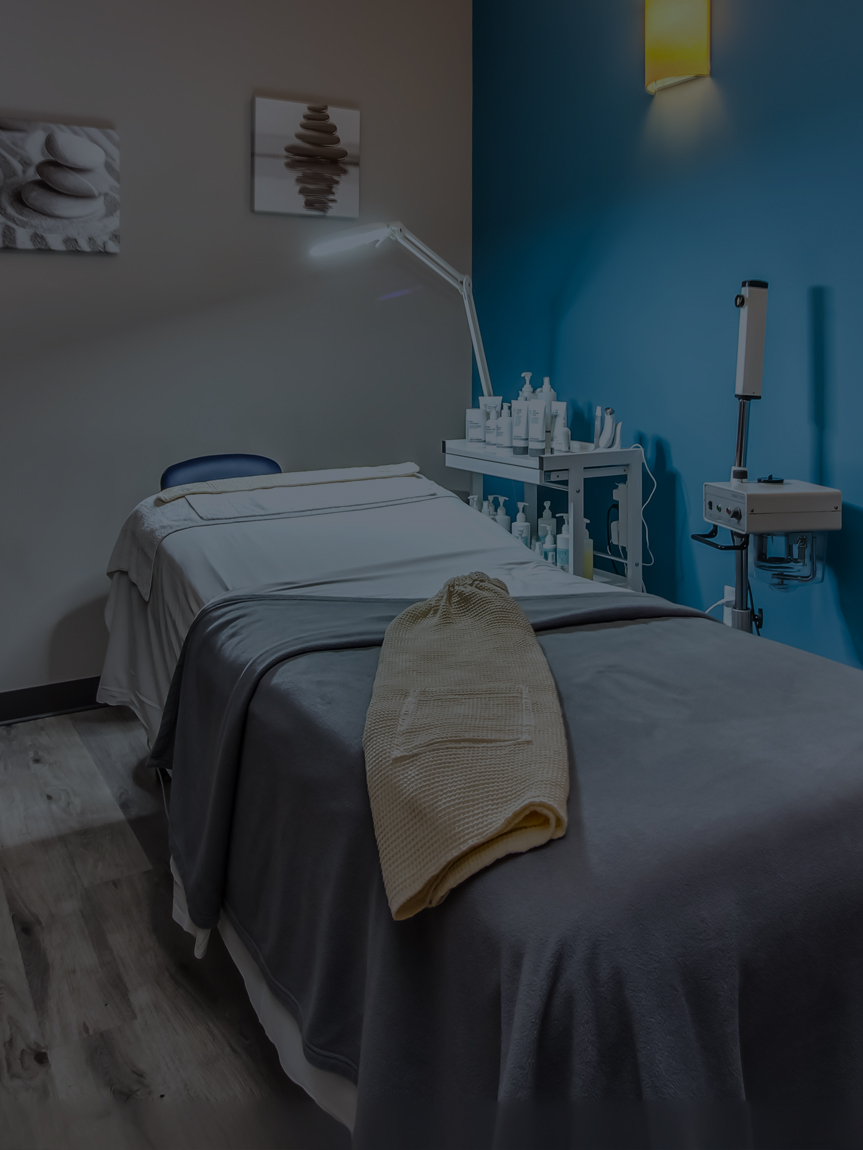 A smiling woman enjoying an expert massage service at Hand & Stone Massage and Facial Spa.